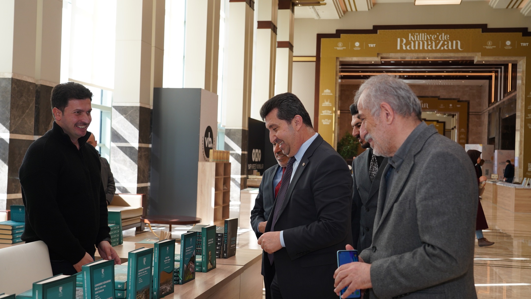 ASBÜ Rektörü Prof. Dr. Musa Kazım ARICAN ve ASBÜ Kütüphane Daire Başkanı Osman KAYAER fuardaki standlarda kitapları inceliyorlar.